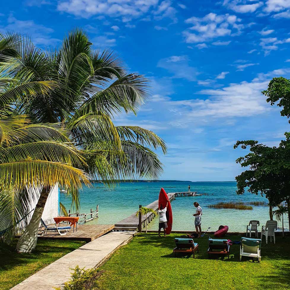 Bacalar Lagoon beach, canoes and palm trees, Yucatan, Mexico