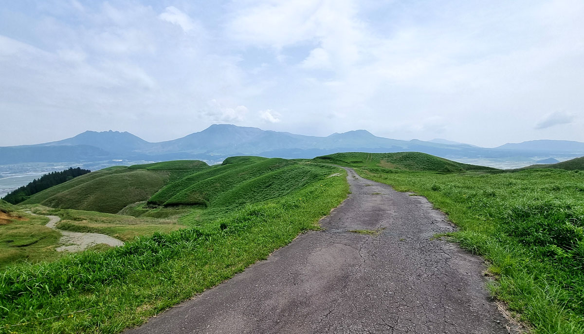 Small road over volcanic landscapes of Aso, Japan