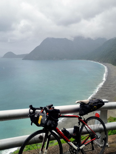 Touring road bike in front of east coast ocean panorama, Taiwan.